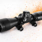 Black rifle scope on a textured white surface